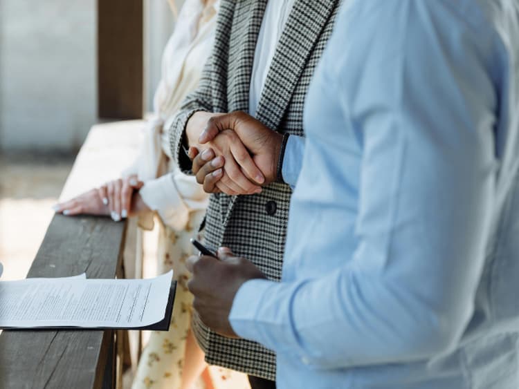 Business handshake representing client agreement and payment terms