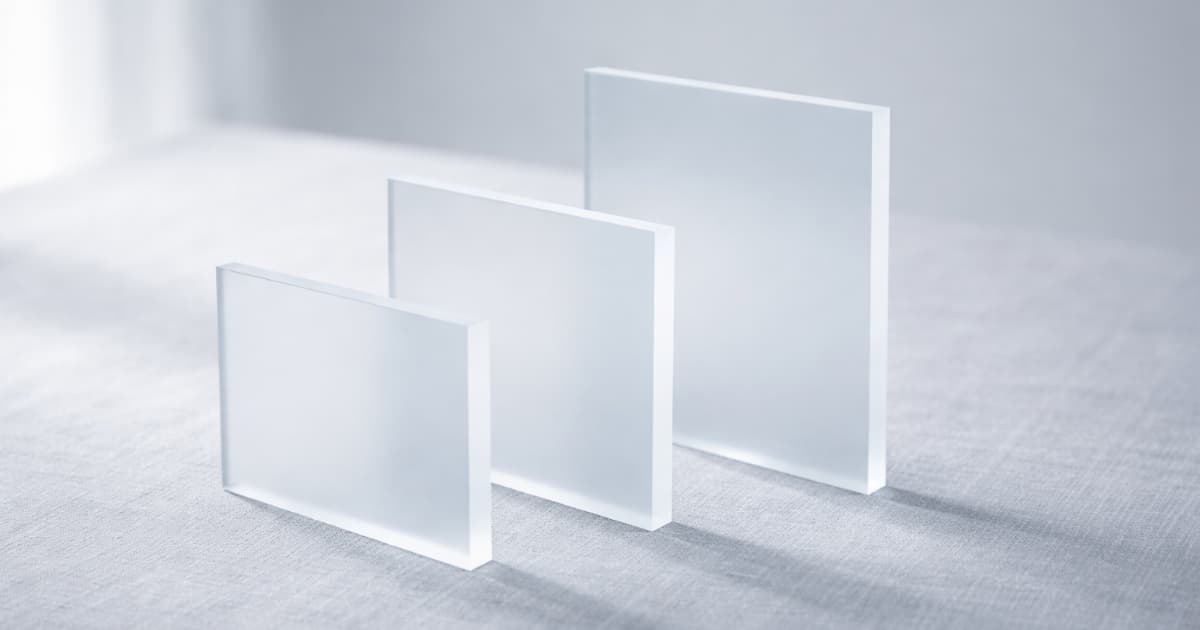 Frosted acrylic panels of varied heights on linen, suggesting structured scope and service tiers