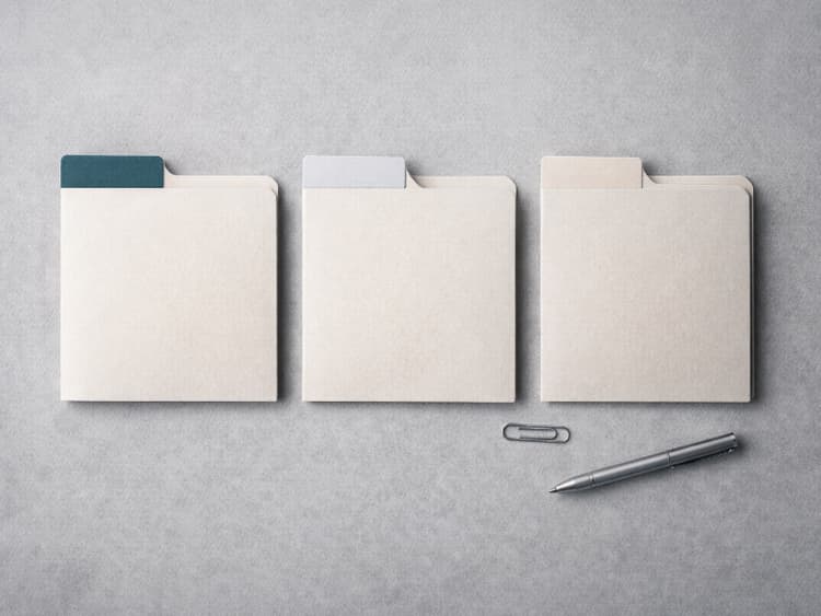Neatly labeled dividers and minimal desk items, evoking routing an invoice to the right recipients