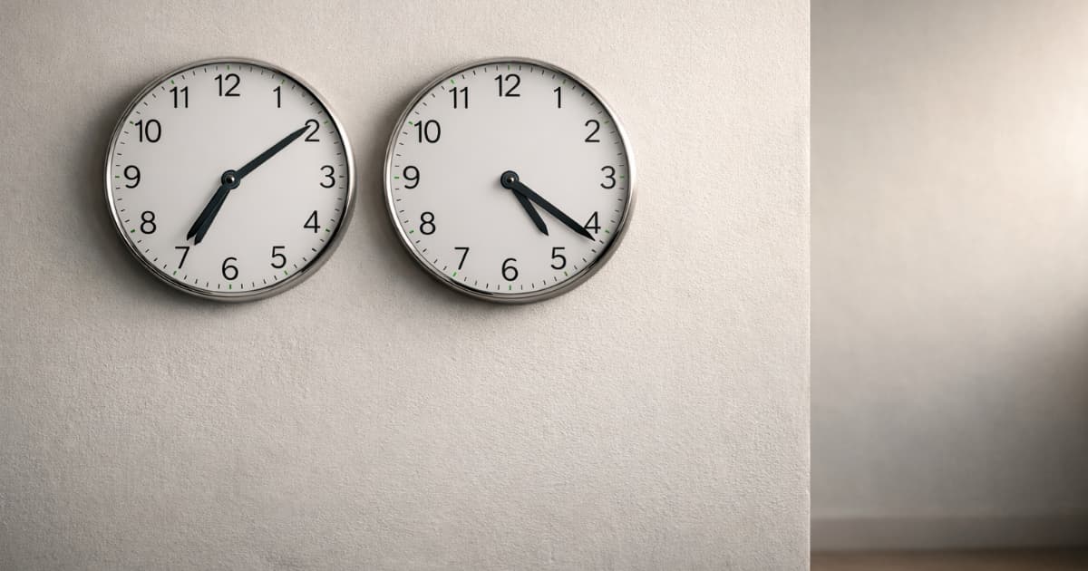 Two wall clocks side by side showing different times, suggesting work and payments across time zones