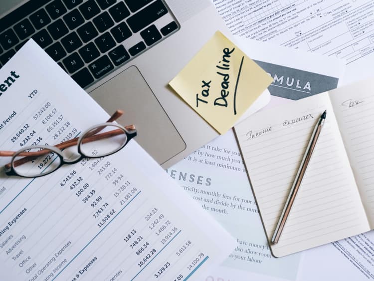 Invoice document on a desk next to a laptop Invoice document on a desk next to a laptop
