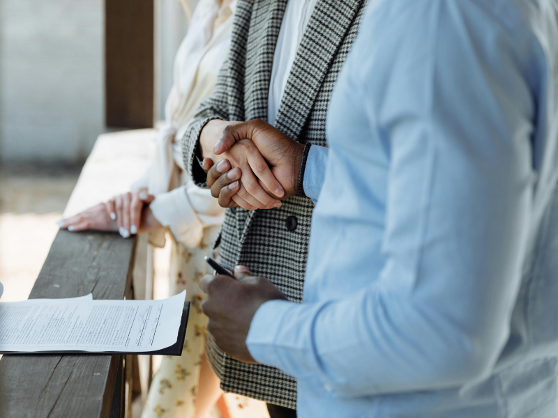 Business handshake representing client agreement and payment terms