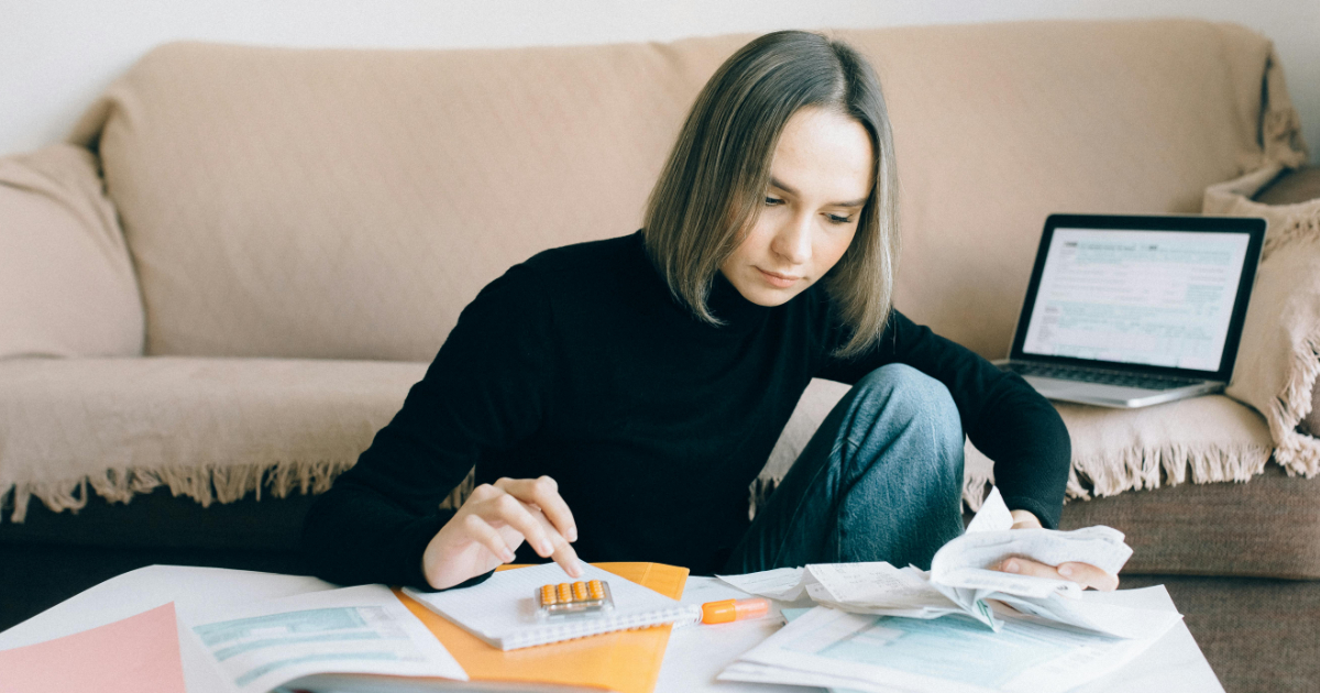 Freelancer planning pricing with calculator and notebook