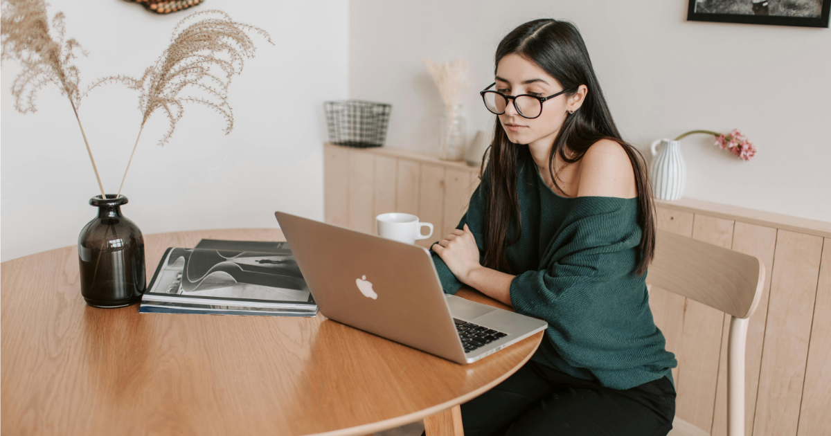 Professional freelancer creating invoice on laptop at modern workspace