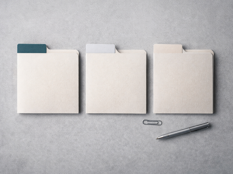 Neatly labeled dividers and minimal desk items, evoking routing an invoice to the right recipients
