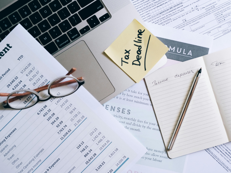 Invoice document on a desk next to a laptop